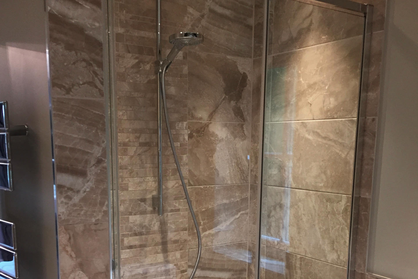 Limestone effect tiling in enclosed shower